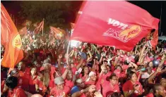  ??  ?? Supporters of the People’s National Movement cheer as Keith Rowley addresses the crowd after the country’s general elections in Port-of-Spain, Trinidad.