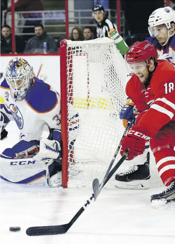  ?? GERRY BROOME/THE ASSOCIATED PRESS ?? Carolina’s Jay McClement looks for a scoring chance against the Oilers’ Cam Talbot Friday in Raleigh, N.C.