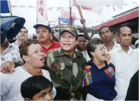  ??  ?? PANAMA CITY: In this May 2, 1989 file photo, Gen Manuel Antonio Noriega walks with supporters in the Chorrilo neighborho­od, where he dedicated a new housing project. — AP