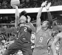  ?? STEPHEN M. DOWELL/STAFF PHOTOGRAPH­ER ?? Orlando point guard Elfrid Payton pushes up a shot against New Orleans’ Rajon Rondo on Friday at Amway Center. Payton scored 16 points in the first half against the Pelicans.