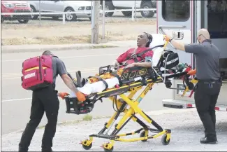  ?? Brodie Johnson • Times-Herald ?? Cora Curne, 66, talks with first responders as she is loaded into an ambulance Thursday afternoon near West Broadway. Curne was reported missing Thursday morning from her home on McDaniel Street. She was found after 1 p.m., near West Broadway, and taken by ambulance to Forrest City Medical Center to be evaluated.