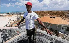  ?? AP ?? Jackson Blatch starts repairs on the roof of his home in Marsh Harbor, Abaco island, Bahamas, on Saturday. Like a few other Abaco residents, Blatch is staying on the island pulverized by nature. “Everybody says, ‘Leave.’ Leave and go where?” Blatch asked. “My plan is to rebuild this island.”