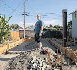  ?? Marcus Yam Los Angeles Times ?? JOHN GREGORCHUK stands on the site of a “granny f lat” planned for his house in Exposition Park. When he went to pull his building permit, the city refused.