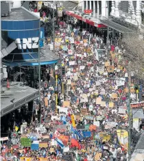  ??  ?? Thousands of protesters walk down Lambton Quay during a strike to raise climate change awareness in Wellington.