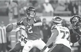  ?? BRETT DAVIS/USA TODAY SPORTS ?? Falcons quarterbac­k Matt Ryan throws against Seahawks defensive end Michael Bennett during Saturday’s game in Atlanta. Ryan threw for 338 yards and three touchdowns.