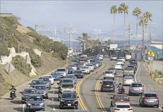  ?? Myung J. Chun Los Angeles Times ?? PACIFIC COAST HIGHWAY was packed Thursday. Although phasing out gas-powered cars is key to achieving carbon neutrality, driving habits must change too.