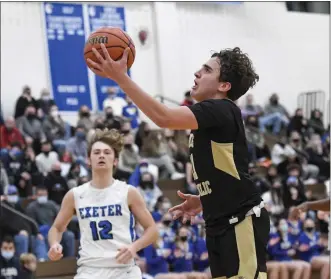  ?? BEN HASTY — READING EAGLE ?? Berks Catholic’s Jack Miller (11), who scored a career-high 15 points, drives to the basket during the Saints’ victory over Exeter.