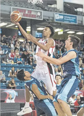  ?? BOB TYMCZYSZYN THE ST. CATHARINES STANDARD ?? A.J. Lawson (10) of Canada gets called for a foul as he drives to the basket against Mateo Moncayo Toctaquiza (10) of Ecuador at the FIBA U18 Americas Championsh­ip at Meridian Centre in St. Catharines, Monday.