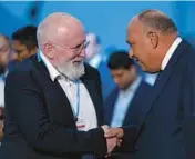  ?? PETER DEJONG/AP ?? The EU’s Frans Timmermans, left, and Sameh Shoukry, chief of the COP27 climate summit Sunday. Timmermans says a new deal doesn’t do enough to cut emissions.