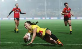  ?? Photograph: George Wood/Getty Images ?? Isabelle Kelly scores Australia’s third try of 15 in a bruising semi-final for Papua New Guinea.
