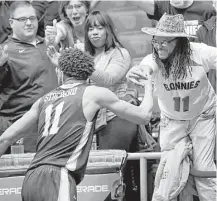  ?? Joe Robbins / Getty Images ?? Guard Courtney Stockard, who had 26 points, shares the joy of beating UCLA with the St. Bonaventur­e fans.