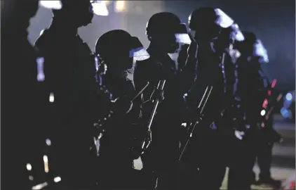  ?? AP PHOTO/RINGO H.W. CHIU ?? In this 2020 file photo, police hold their clubs as they form a line in front of supporters of President Donald Trump on Election Day in Beverly Hills, Calif.