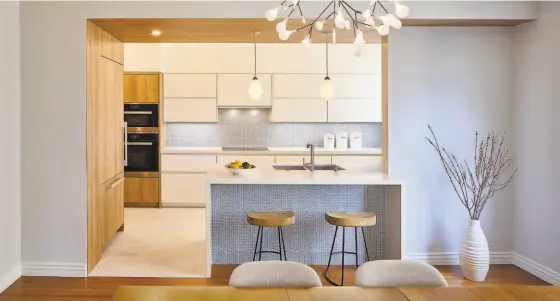  ?? Photos by Keith Baker ?? Above: A starburst chandelier illuminate­s a dining area set beside an open kitchen at this home on Jackson Street designed by San Francisco’s Y.A. Studio. Below: Architect Yakuh Askew, principal of San Francisco’s Y.A. Studio, designed this condo building in Potrero Hill.