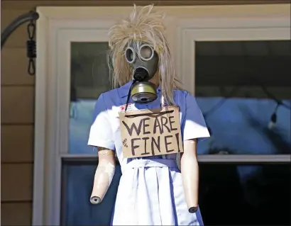  ?? MATT FREED — THE ASSOCIATED PRESS ?? A resident displays a mannequin on their porch in East Palestine, Ohio, as cleanup from the Feb. 3 Norfolk Southern train derailment continues, Friday, Feb. 24, 2023.