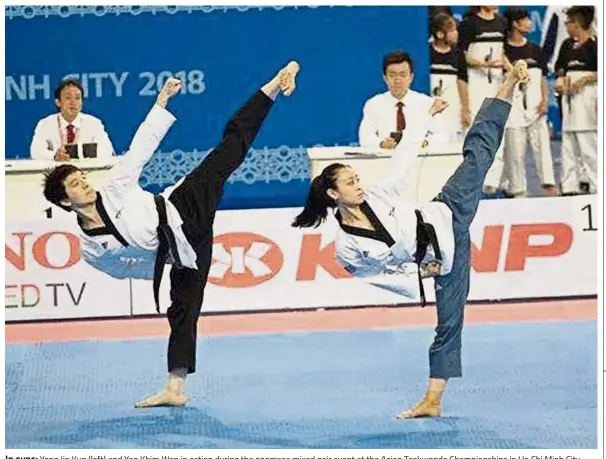  ??  ?? In sync: Yong Jin Kun (left) and Yap Khim Wen in action during the poomsae mixed pair event at the Asian Taekwondo Championsh­ips in Ho Chi Minh City, Vietnam, yesterday.