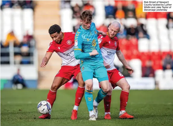  ?? ?? Rob Street of Newport County tackled by Luther Wildin and Jake Taylor of Stevenage yesterday