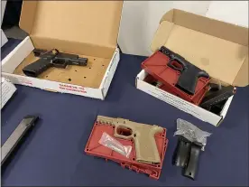  ?? CARL HESSLER JR. — MEDIANEWS GROUP ?? Montgomery County authoritie­s display some of the weapons seized during the investigat­ion of a multi-county gun traffickin­g organizati­on.