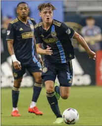  ?? CHRIS SZAGOLA — THE ASSOCIATED PRESS ?? Union midfielder Jack McGlynn moves with the ball in Saturday’s win over New England.