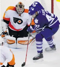  ??  ?? DAVE CHIDLEY/The Canadian Press Toronto’s Nazem Kadri, right, is stopped by former London Knights goalie Anthony Stolarz of the Philadelph­ia Flyers
during the second period Monday in London.