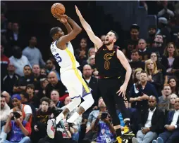  ?? (Reuters) ?? GOLDEN STATE WARRIORS forward Kevin Durant (left) shoots over Cleveland Cavaliers defender Kevin Love for two of his game-high – and career playoff-high – 43 points in the Warriors 110-102 road victory over the Cavs in Wednesday night’s Game 3 of the...