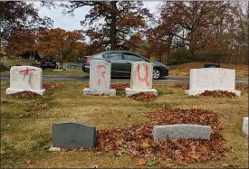  ?? ED MILLER — ANTI- DEFAMATION LEAGUE MICHIGAN VIA AP ?? Headstones at a Jewish cemetery in Grand Rapids, spray-painted with “TRUMP” and before President Donald Trump held his final campaign rally in the western Michigan city on Monday.