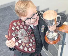  ?? Pictures: Sandy McCook. ?? Alasdair Macinnes showing his trophies from the Mod