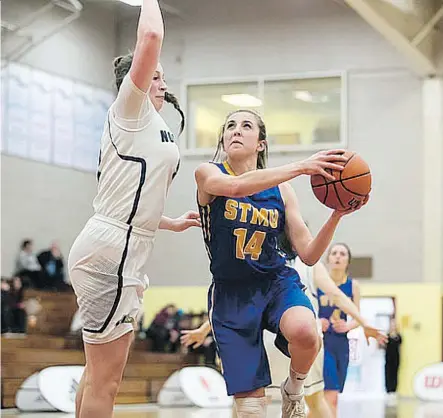  ??  ?? Emily Wagner, right, of the St. Mary’s Lightning, drives to the basket in Thursday’s 76-58 defeat at the hands of the Montmorenc­y Nomades at the CCAA national women’s basketball championsh­ips ongoing in Sackville, N.B. The Lightning can only win bronze...