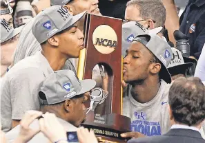  ?? AP FILE PHOTO BY BILL HABER ?? Anthony Davis, left, kissed Kentucky’s NCAA trophy in 2012 and won the Lakers’ NBA title 8 years later.