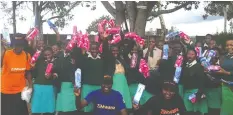  ??  ?? ZiMwana officials (in t-shirts and caps) pose for a photo after donating pads to high school students
