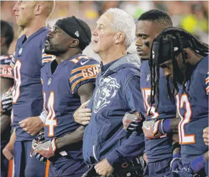  ?? | JONATHAN DANIEL/ GETTY IMAGES ?? “Love goes way further than hate,” says John Fox ( center), linking arms with his players in Green Bay.