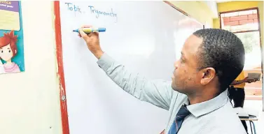  ??  ?? Mathematic­s Teacher of the Year Oneal McLeod sets up the lesson for the day in his third-form classroom. The topic? You guessed it, trigonomet­ry. Godfrey Stewart is positionin­g itself to become the mathematic­s centre of Westmorela­nd in the short term.