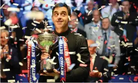  ?? ?? Ronnie O'Sullivan poses with the trophy after his form in the evening session saw off Judd Trump in the World Championsh­ip Snooker final. Photograph: Oli Scarff/AFP/Getty Images