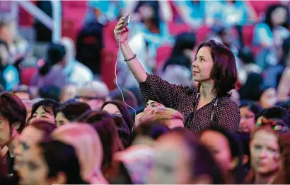  ?? James Nielsen photos / Houston Chronicle ?? Cintia Barcelos takes a selfie Wednesday during the Grace Hopper Celebratio­n of Women in Computing conference.