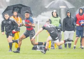  ?? Photo / Warren Buckland ?? Hastings Boys’ High School winger Joeli Rauca prepares to fend off Hamilton Boys’ High School centre and birthday boy Josh Calvert during Hastings’ loss on Saturday.