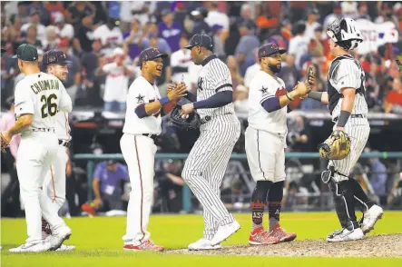  ?? Gregory Shamus / Getty Images ?? The postgame American League handshake line included A’s third baseman Matt Chapman (left), who walked and scored.