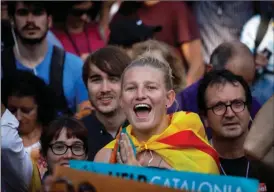  ?? The Associated Press ?? Pro-independen­ce demonstrat­ors cheer outside Catalan parliament in Barcelona, Spain, on Friday. Catalan lawmakers voted Friday to secede from Spain, shortly before Spain’s Senate approved a request by the government to take control of Catalonia’s...