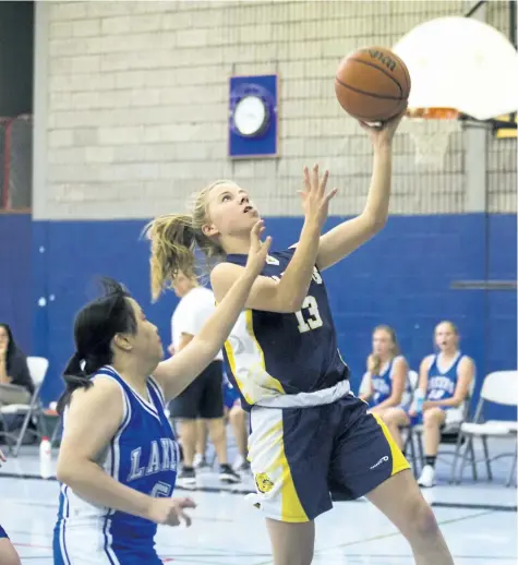  ?? BOB TYMCZYSZYN/POSTMEDIA NEWS ?? Sir Winston Churchill Bulldogs senior girls play Great Lakes Christian College Lakers on Thursday. Ally Sentance (13) drives to the basket against Eunice Cheung (5).