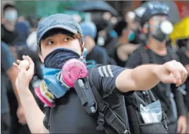  ?? Vincent Thian The Associated Press ?? A protester throws an egg at a police station Sunday in Hong Kong. More rallies were held Sunday after police announced more than 20 arrests after recent clashes.