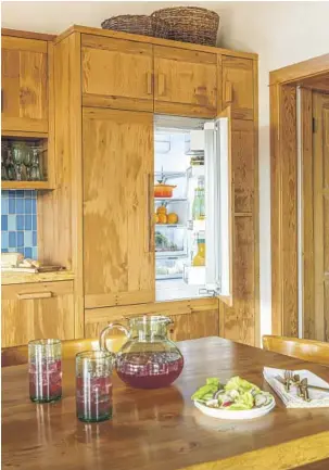  ??  ?? THE KITCHEN features all-electric appliances, making it more efficient and cooler. A centuryold barn on the property, left, was dismantled, and parts were used by Home Front Build in the constructi­on of the ADU.