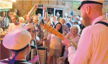  ?? Photo / Supplied ?? The Wellington Sea Shanty Society putting on a rambunctio­us show at Kairakau Camping Ground hall for the Small Hall Sessions in January.