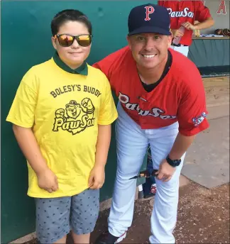  ?? Photo by Brendan McGair ?? Pawtucket Red Sox manager Kevin Boles poses with 10-year-old A.J. Butler of Foxboro, who on Sunday officially became a “Bolsey’s Buddy.” The program was introduced by the PawSox earlier this summer where a youngster is randomly chosen to walk out to home plate with Boles prior to first pitch at McCoy Stadium.