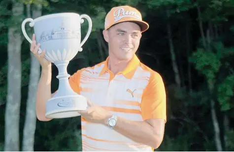  ?? — USA Today Sports ?? Rickie Fowler holds the Deutsche Bank Championsh­ip trophy after winning the tournament at TPC of Boston.