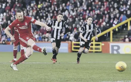  ??  ?? 0 Adam Rooney fires in the penalty which put Aberdeen on the road to an impressive win over Championsh­ip leaders St Mirren.