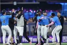  ?? Rich Storry/Getty Images ?? The Marlins’ Emmanuel Rivera celebrates after hitting the winning single against the Phillies Sunday.