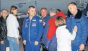  ?? AFP ?? Astronaut Nick Hague (left) and cosmonaut Alexey Ovchinin with family members at the Krayniy Airport in Baikonur.