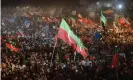  ?? Photograph: Anadolu Agency/Getty Images ?? Supporters of former Imran Khan's Pakistan Tehreek-e-Insaf (PTI) party, hold flags and signs as they gather during a public rally, on 13 April in Peshawar, Pakistan.