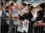  ?? KIRSTY WIGGLESWOR­TH — THE ASSOCIATED PRESS ?? People attend a vigil in Albert Square, Manchester, England, Tuesday the day after the suicide attack at an Ariana Grande concert that left 22 people dead as it ended on Monday night.
