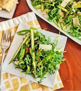  ?? Gretchen McKay/Post-Gazette photos ?? Shaved asparagus and baby arugula are tossed with lemon juice and citrus Champagne vinegar to offer a bright taste of spring.