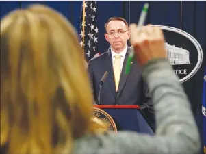  ?? AP PHOTO ?? A reporter raises her hands to ask a question of Deputy Attorney General Rod Rosenstein, after he announced that the office of special counsel Robert Mueller says a grand jury has charged 13 Russian nationals and several Russian entities, Friday.