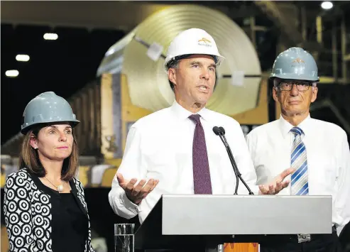  ?? PETER POWER / THE CANADIAN PRESS ?? Finance Minister Bill Morneau speaks to the media about steel tariffs after touring of one of ArcelorMit­tal Dofasco’s galvanizin­g mills in Hamilton on Tuesday.